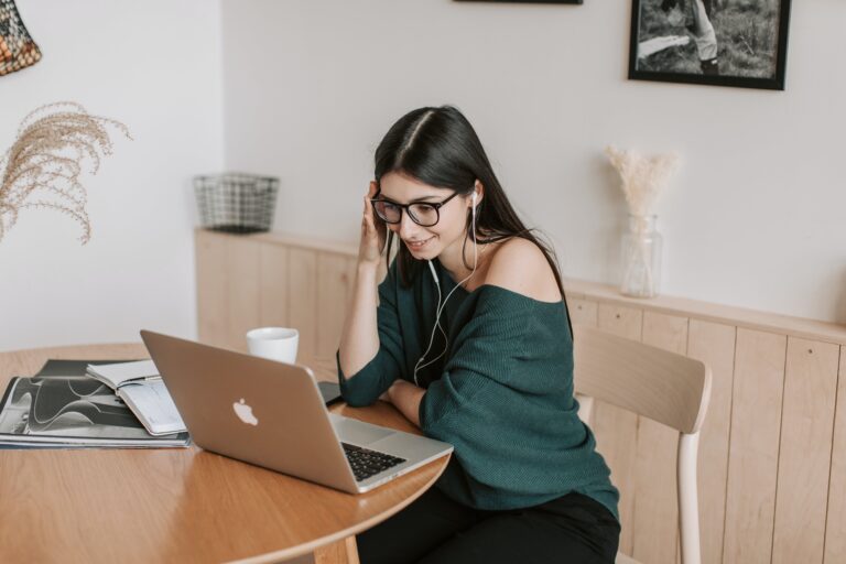 student sitting at desk with laptop